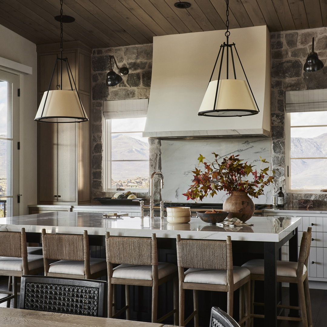 a kitchen with a center island with chairs