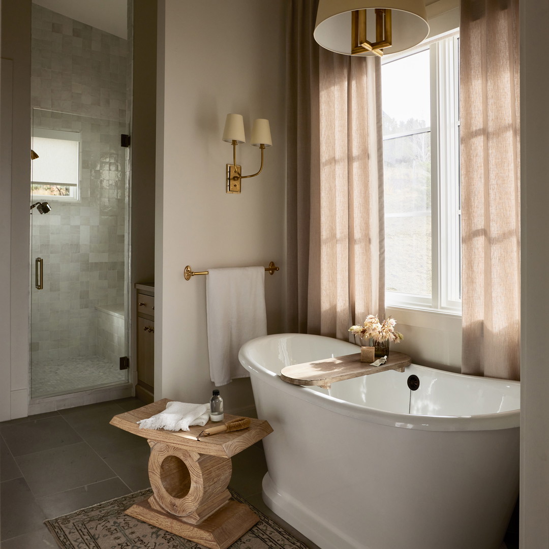 a bathroom with a bathtub and a rug on the floor