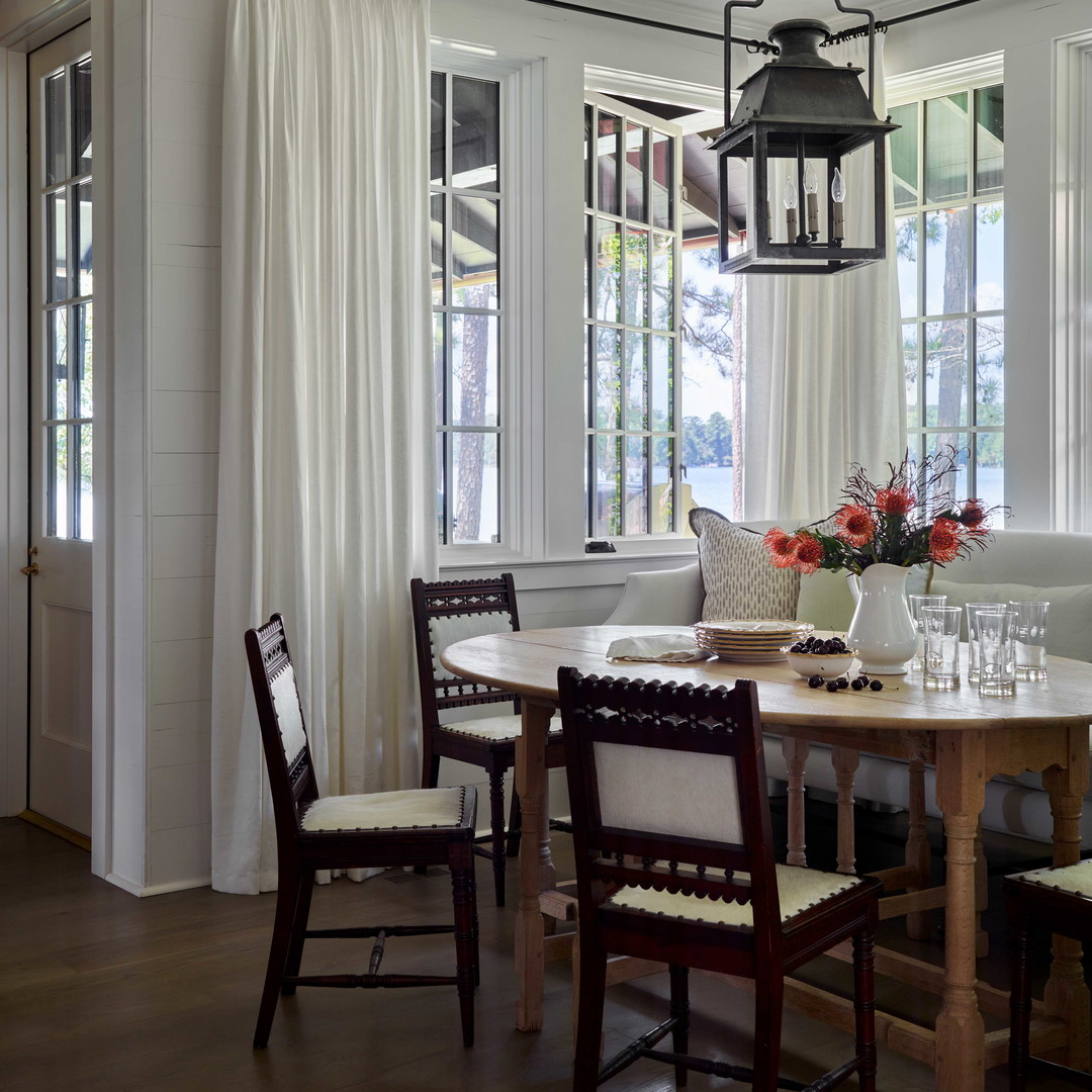 a dining room with a table and chairs