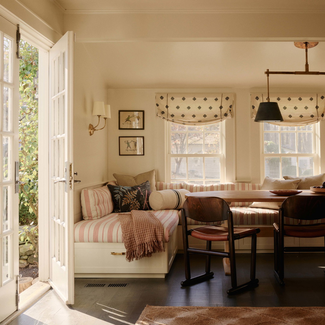 a living room with a couch a table and chairs