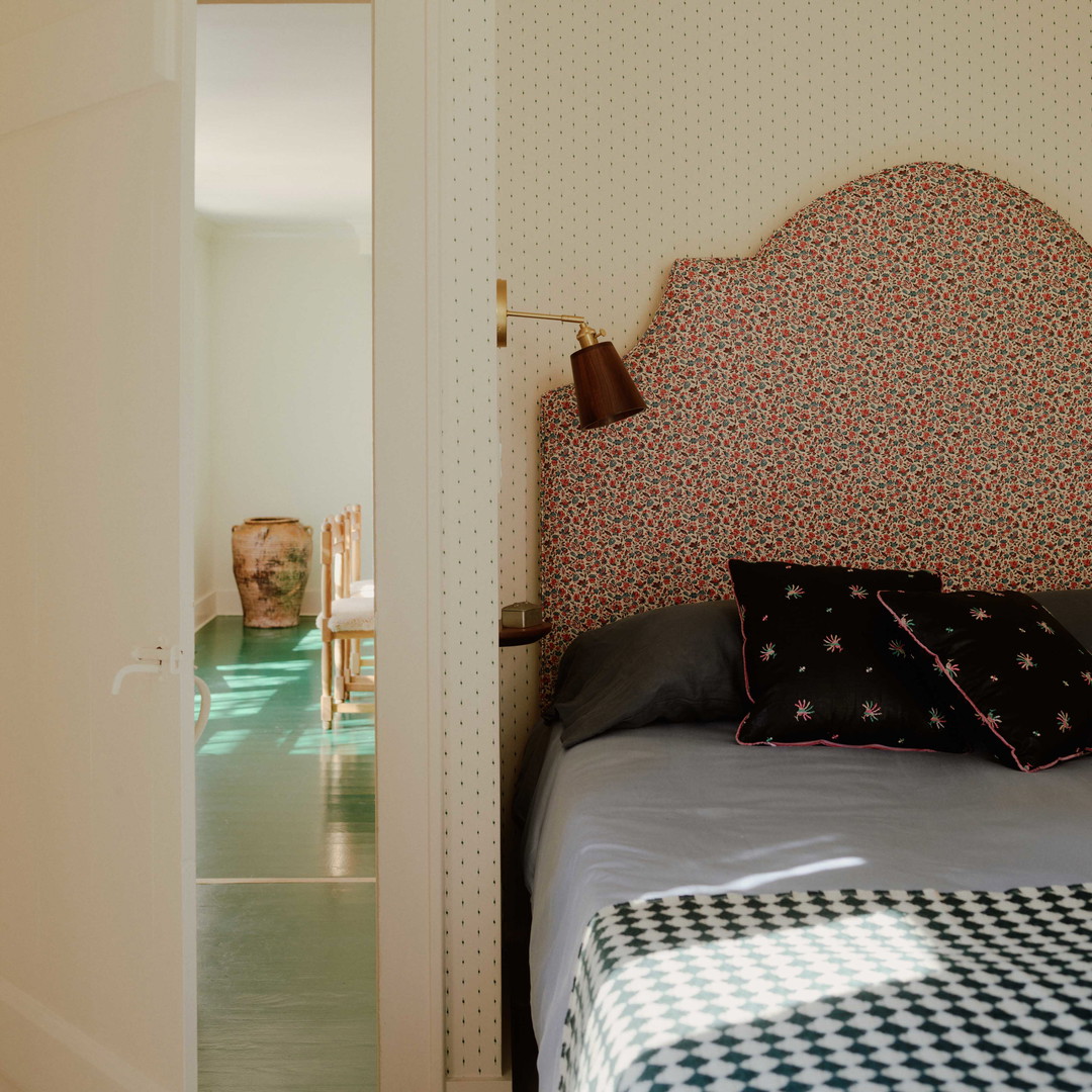 a bed sitting in a bedroom next to a doorway