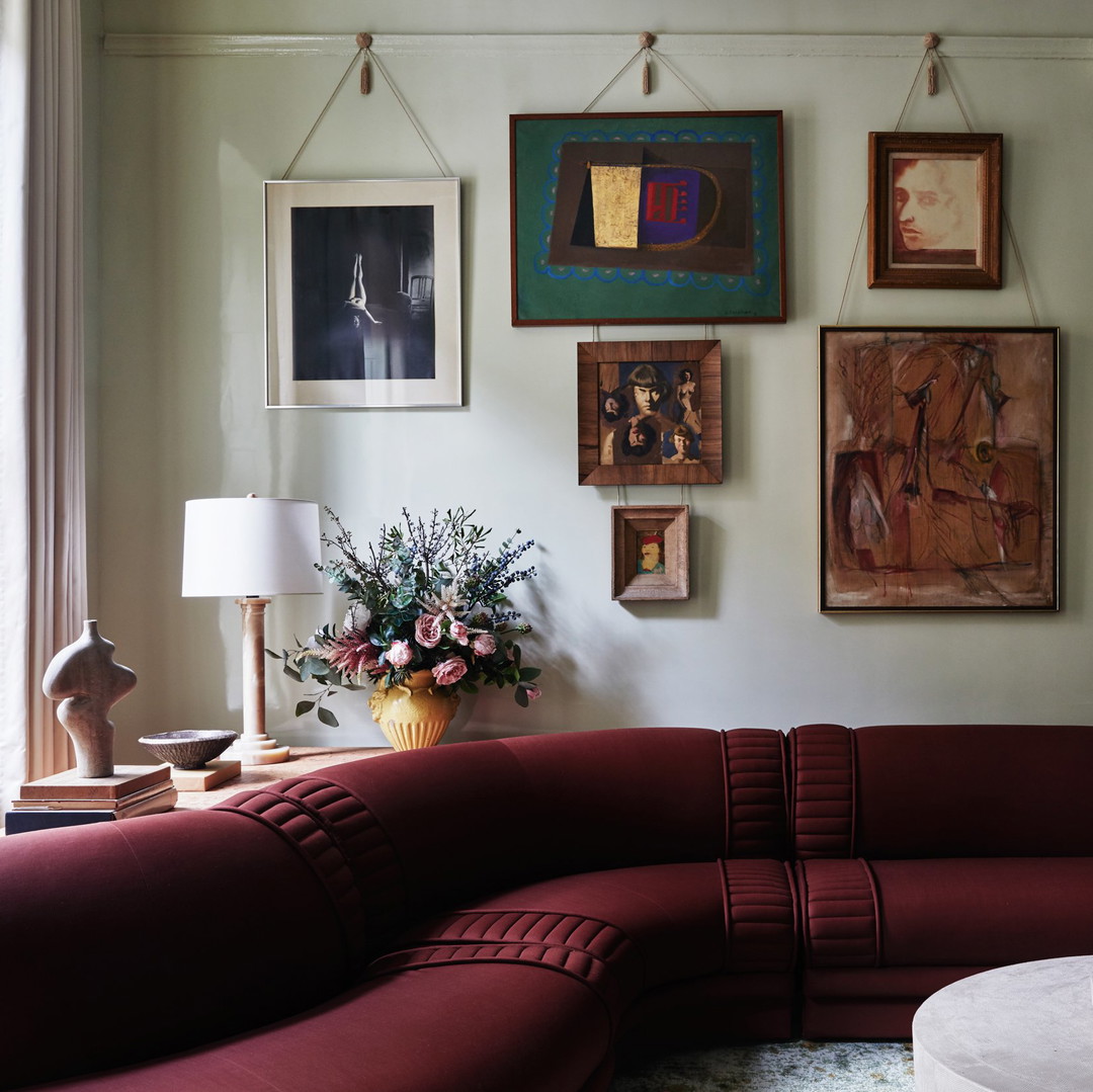 a living room filled with furniture and pictures on the wall