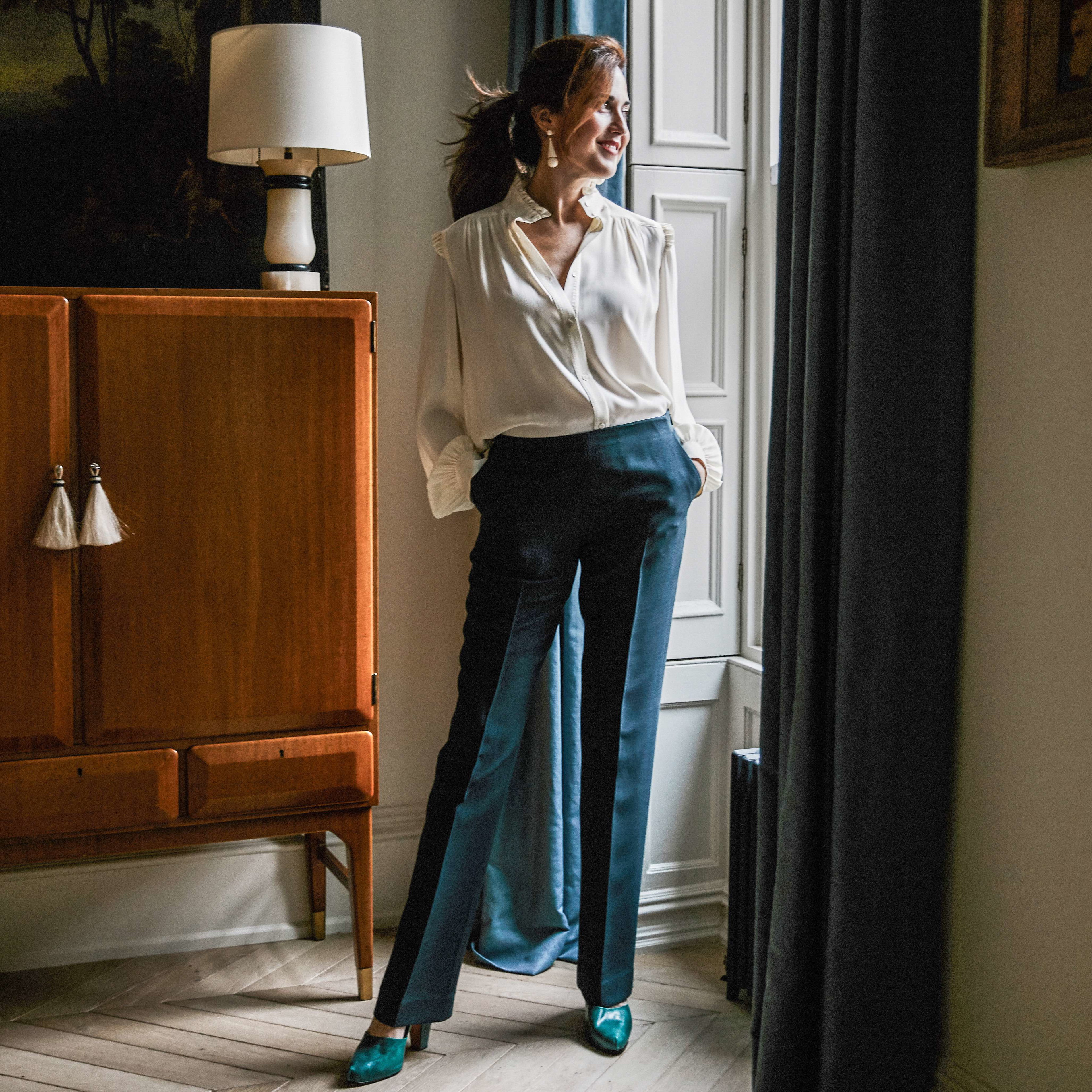 a woman leaning against a window in a room