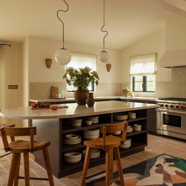 a kitchen with a center island and a stove top oven