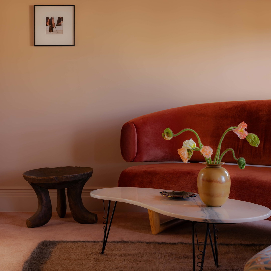 a living room with a red couch and a coffee table