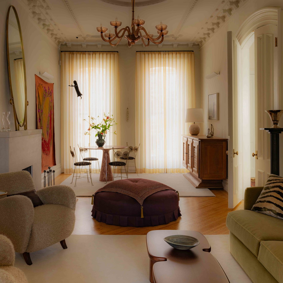 a living room filled with furniture and a chandelier