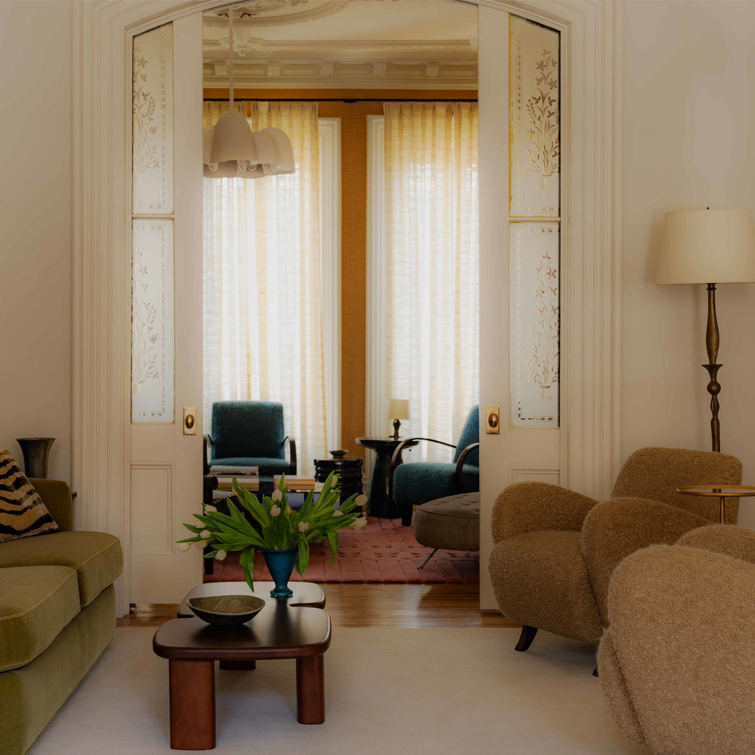 a living room filled with furniture and a mirror