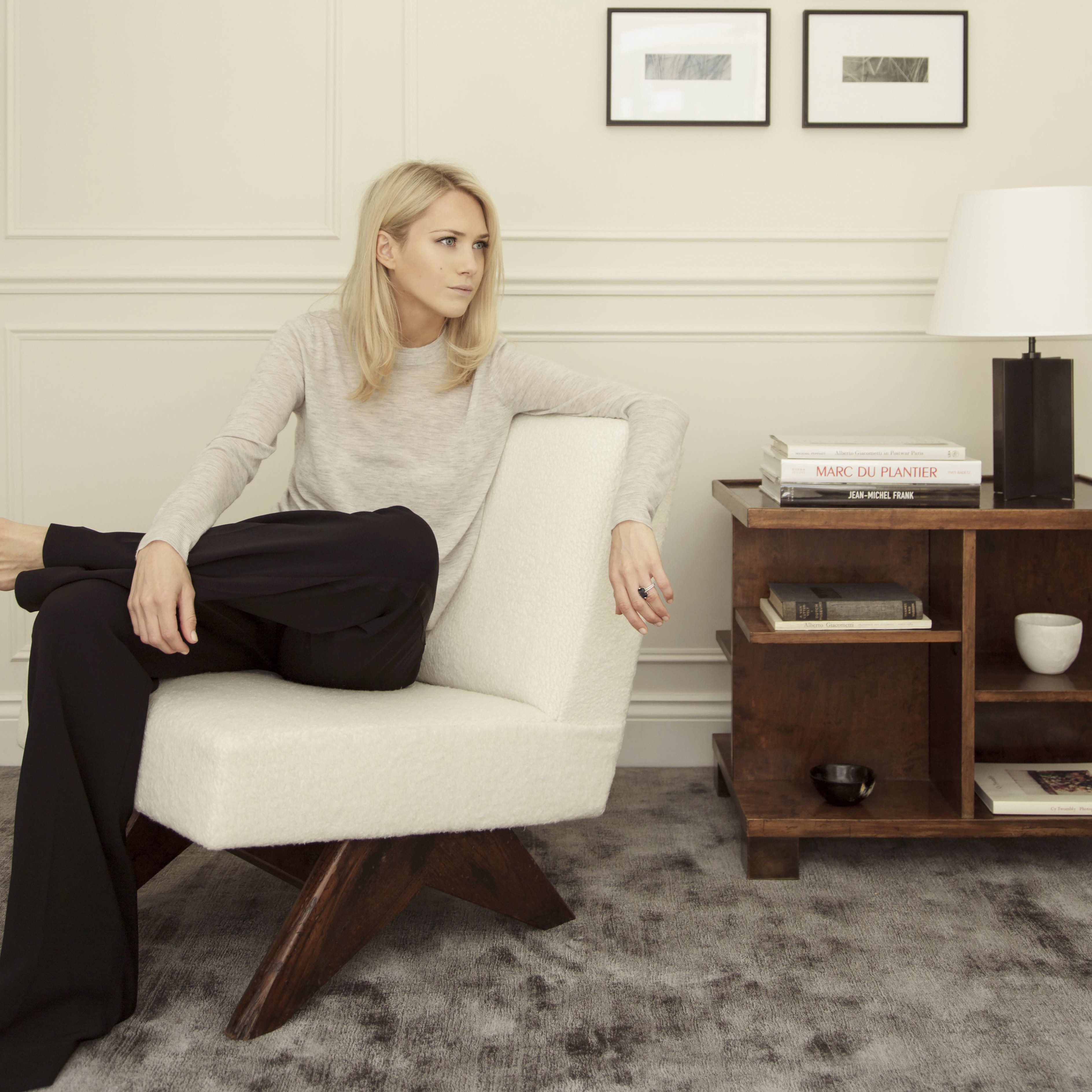 a woman sitting on a chair in a room