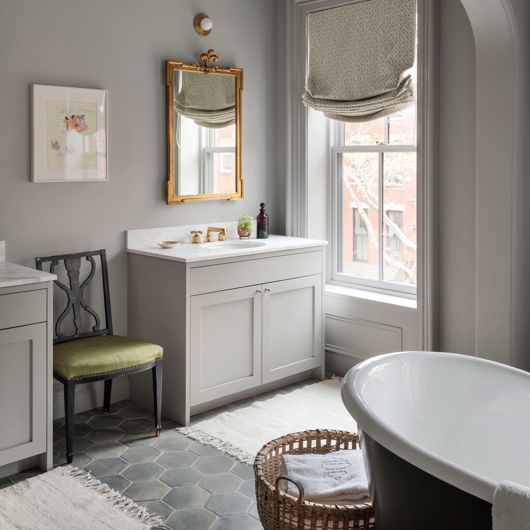 a bath room with a tub a sink and a mirror