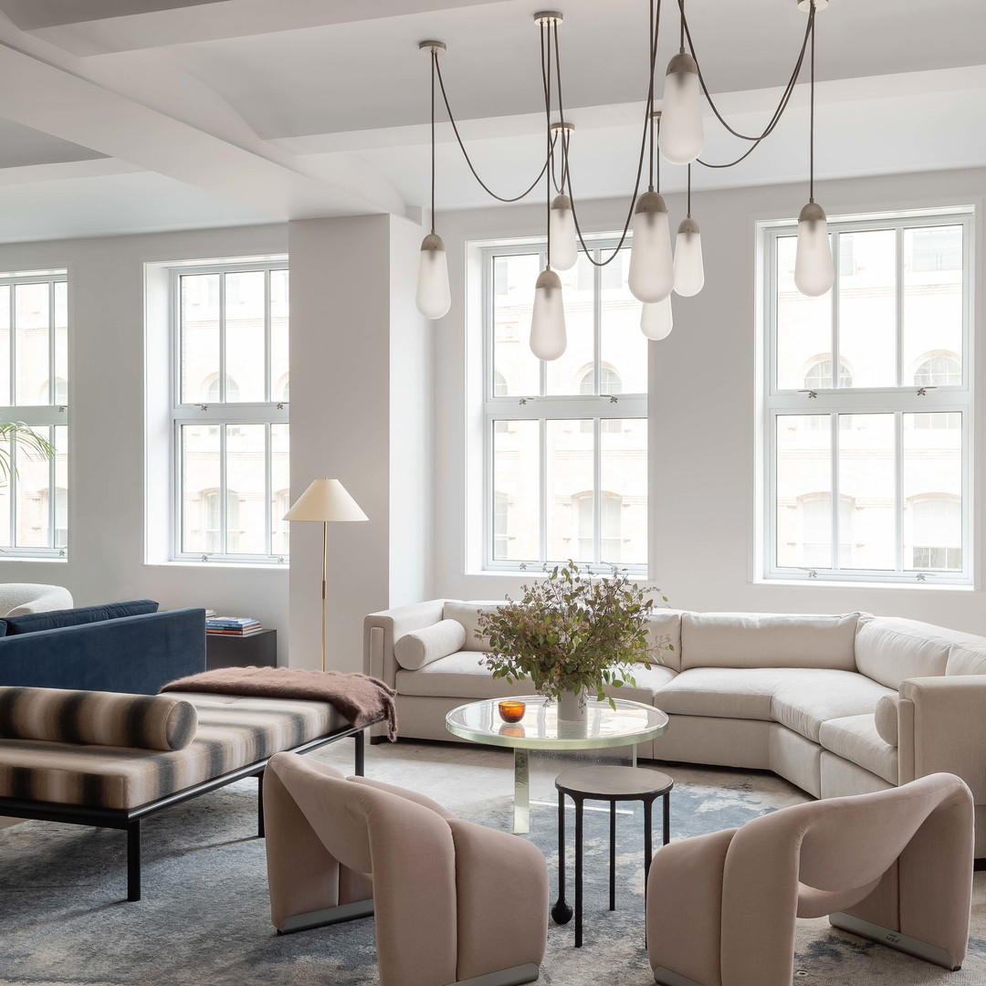 a living room filled with furniture and a chandelier