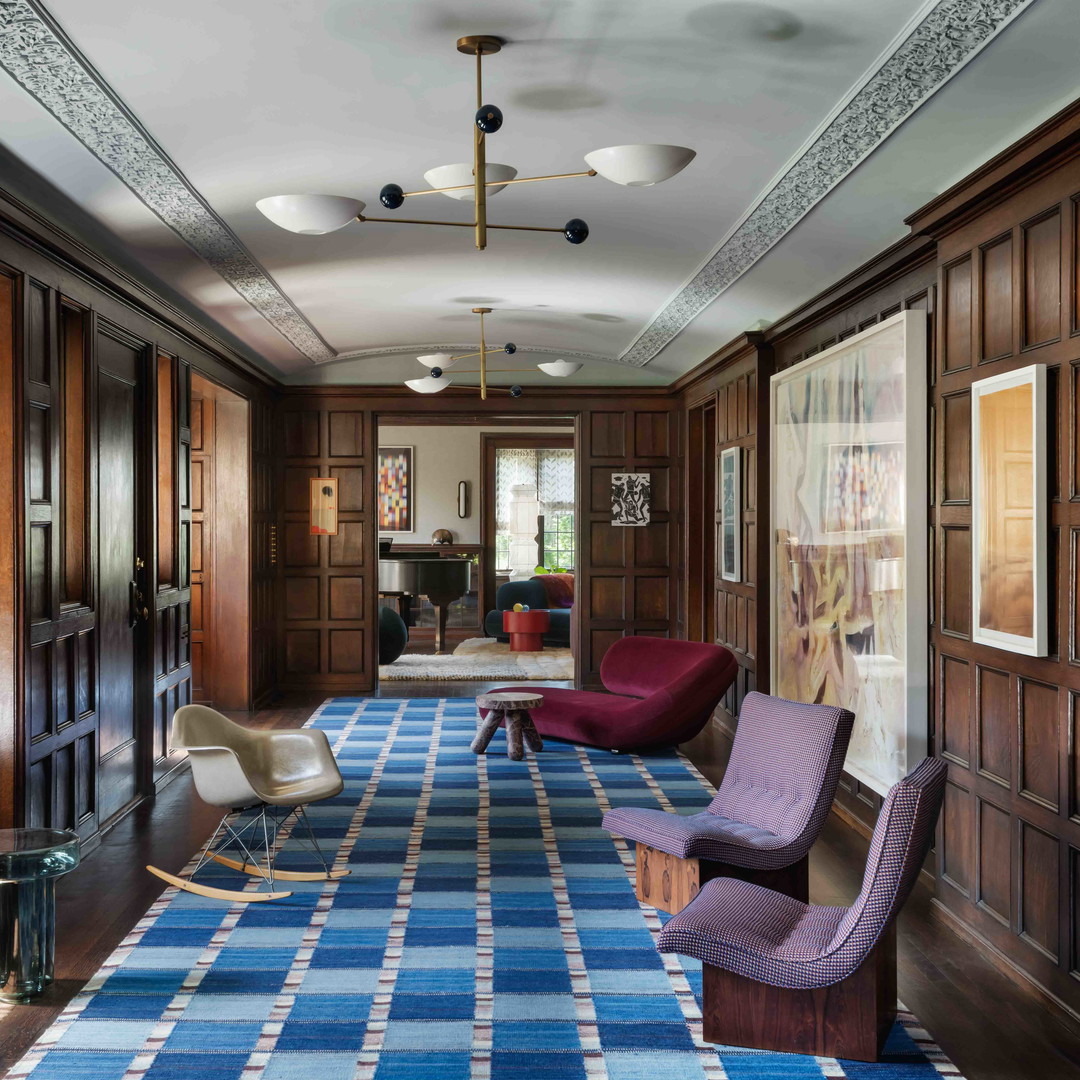 a living room with a blue and white rug