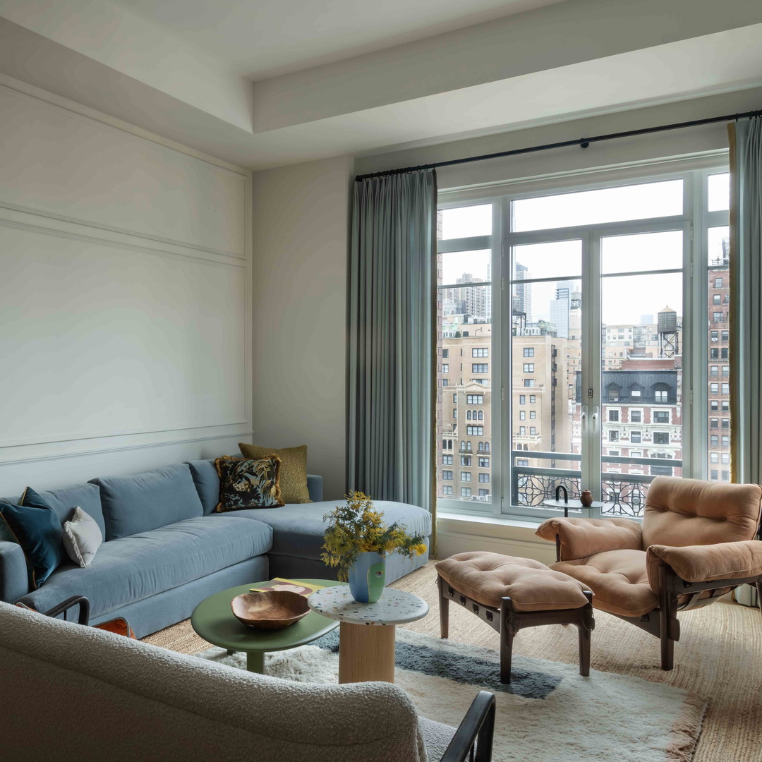 a living room filled with furniture and a large window