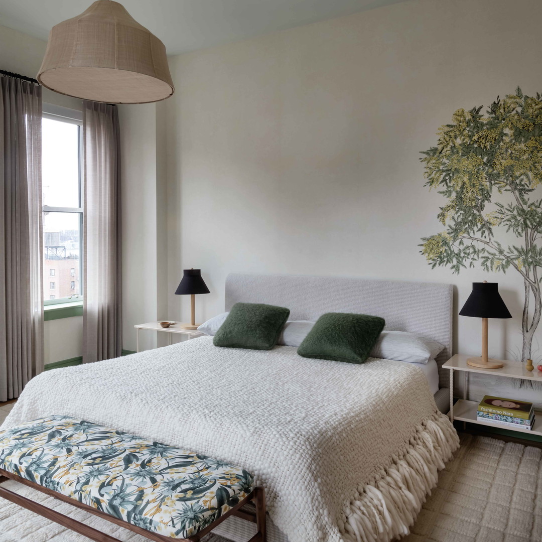 a bedroom with a large bed and a painting on the wall