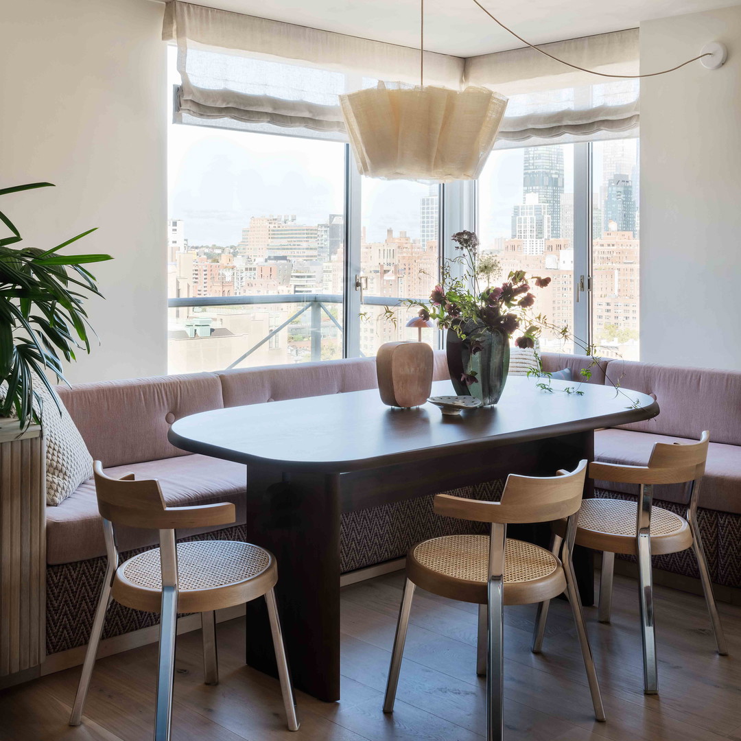 a dining room with a table and chairs