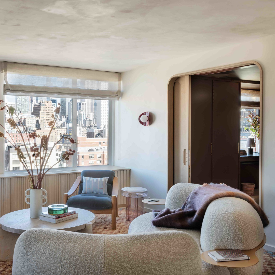 a living room filled with furniture and a large window