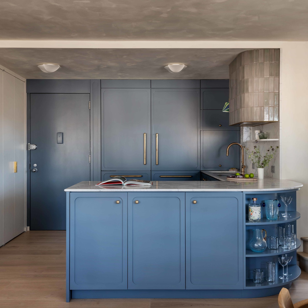 a kitchen with a blue island in the middle of the room