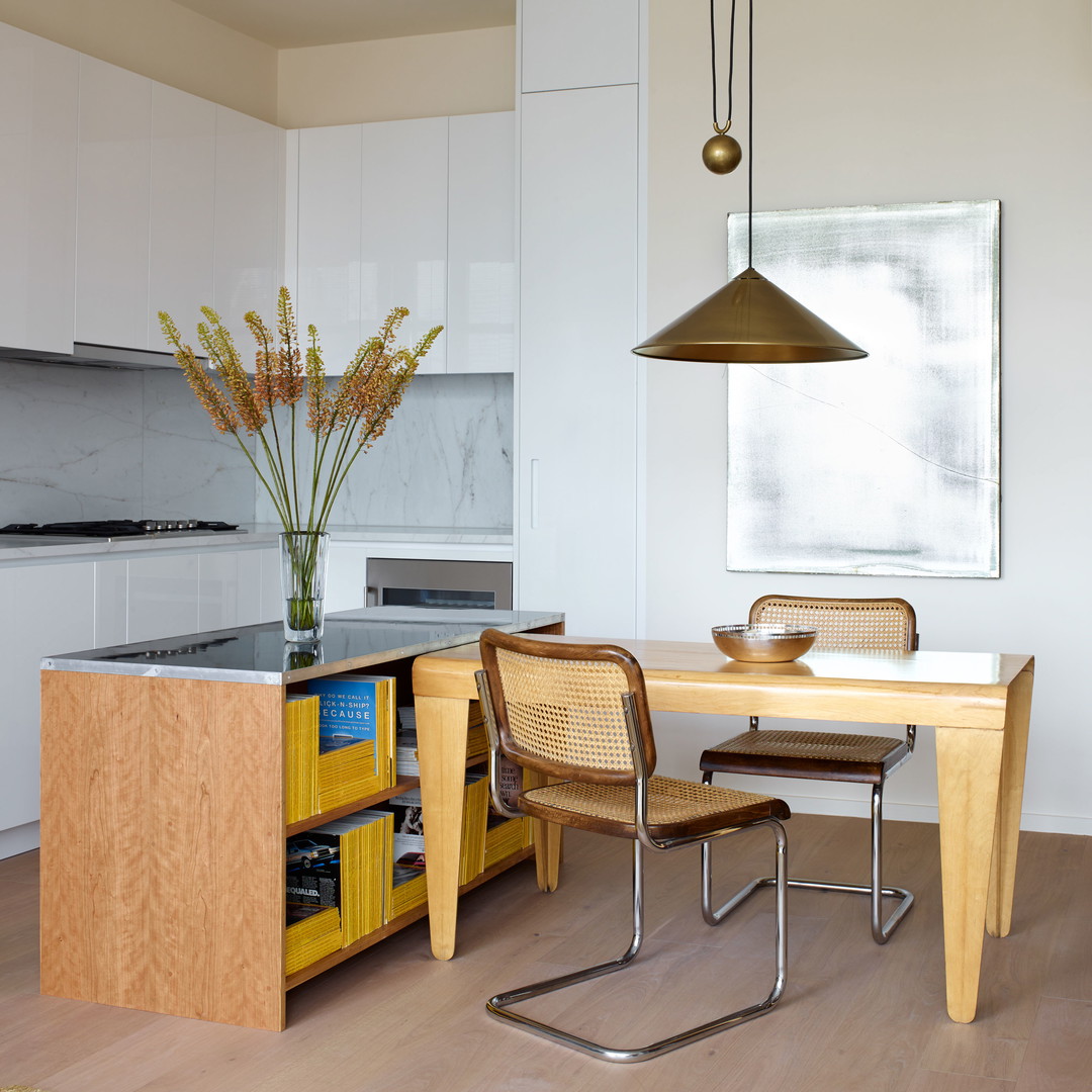 a kitchen with a table, chairs and a sink