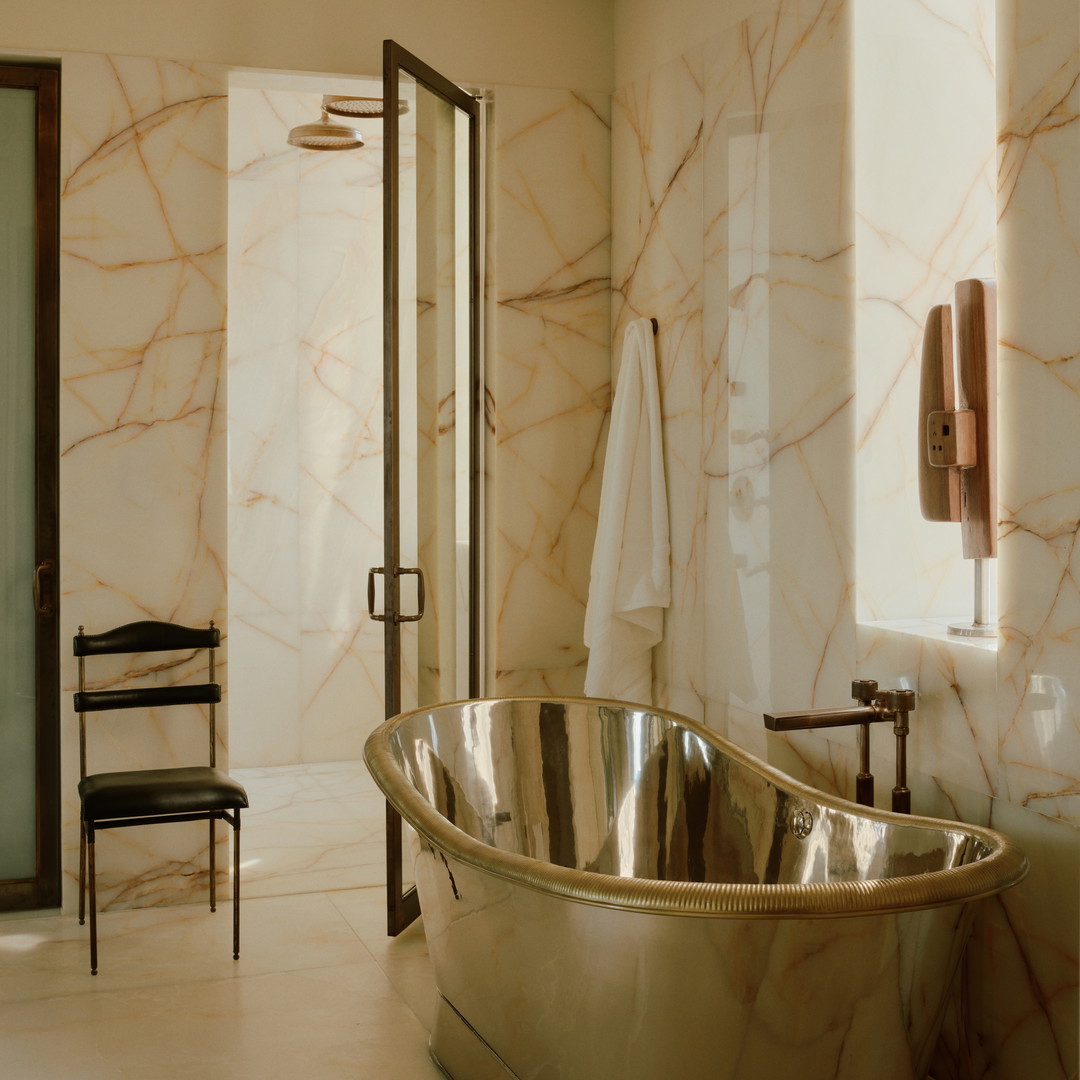 a bathroom with a large bathtub and a chair