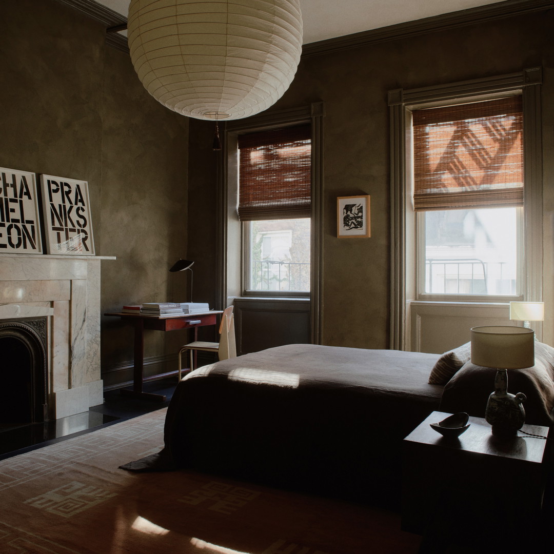 a bedroom with a fireplace and a large bed