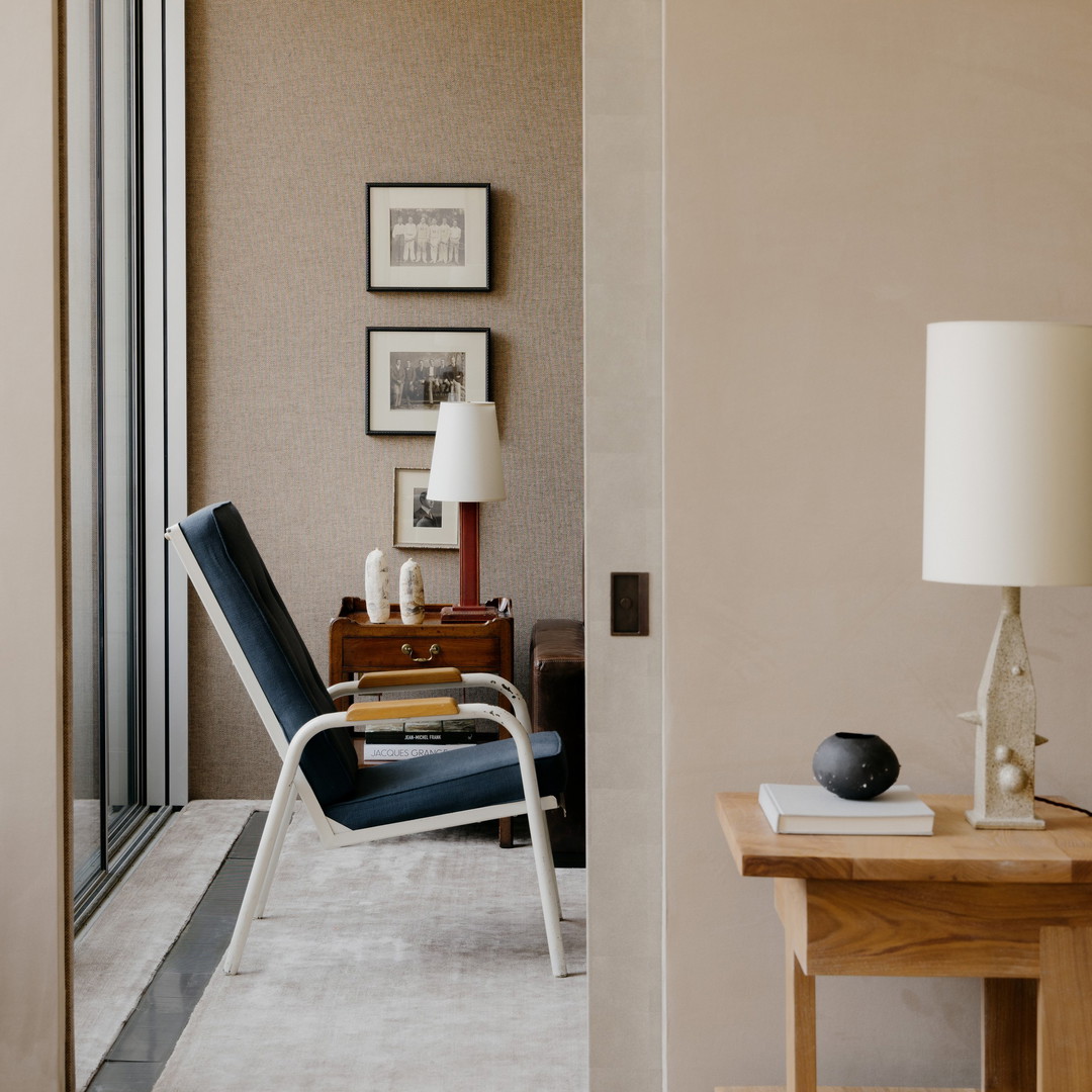 a living room with a chair and a lamp