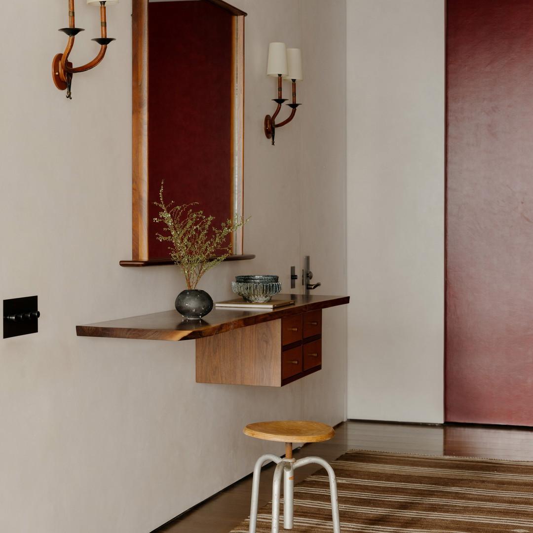 a bathroom with a stool and a mirror