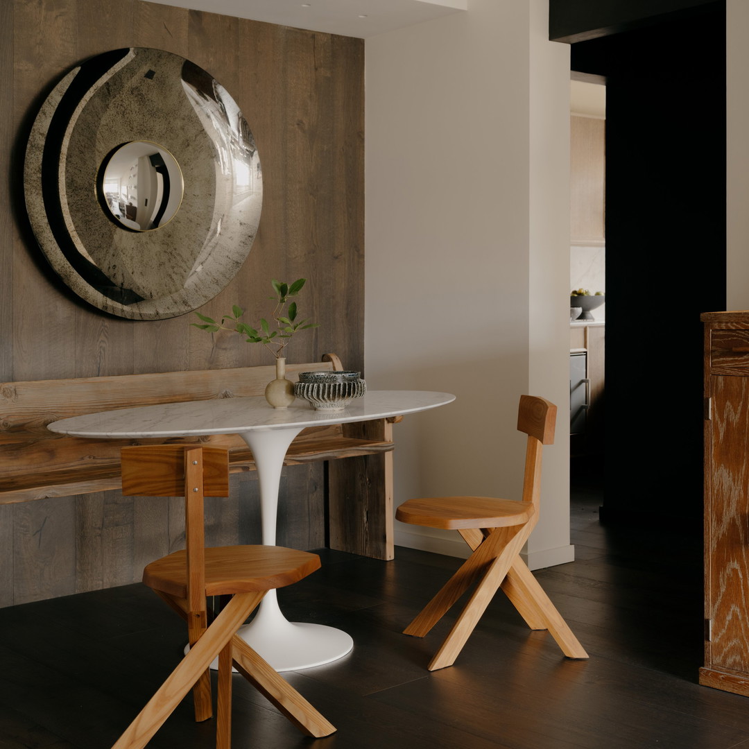 a dining room with a table and two chairs