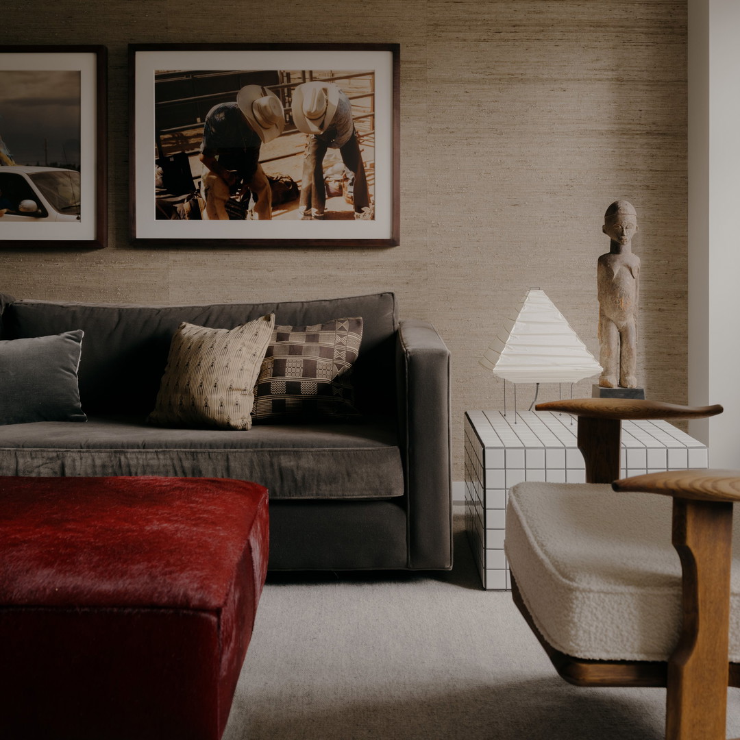 a living room filled with furniture and pictures on the wall