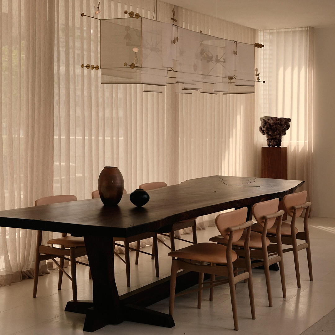 a dining room table with a vase on top of it