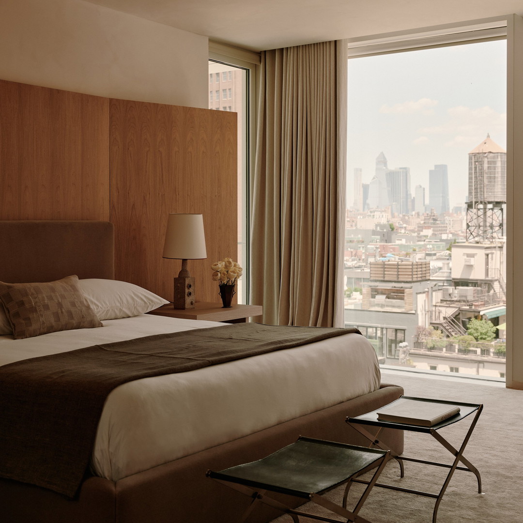 a bedroom with a view of the city