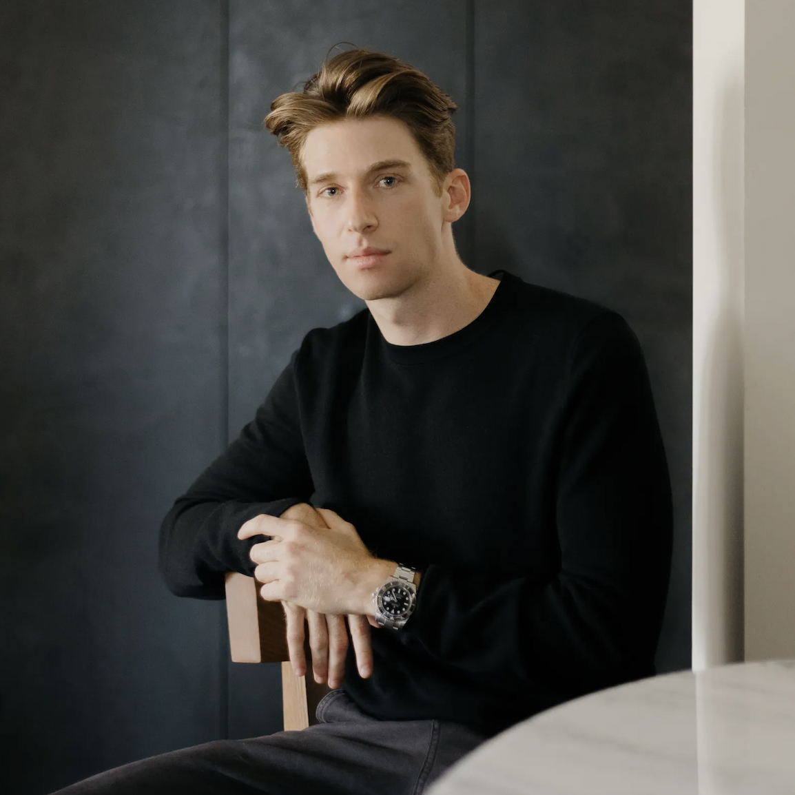 a man sitting in a chair with his arms crossed