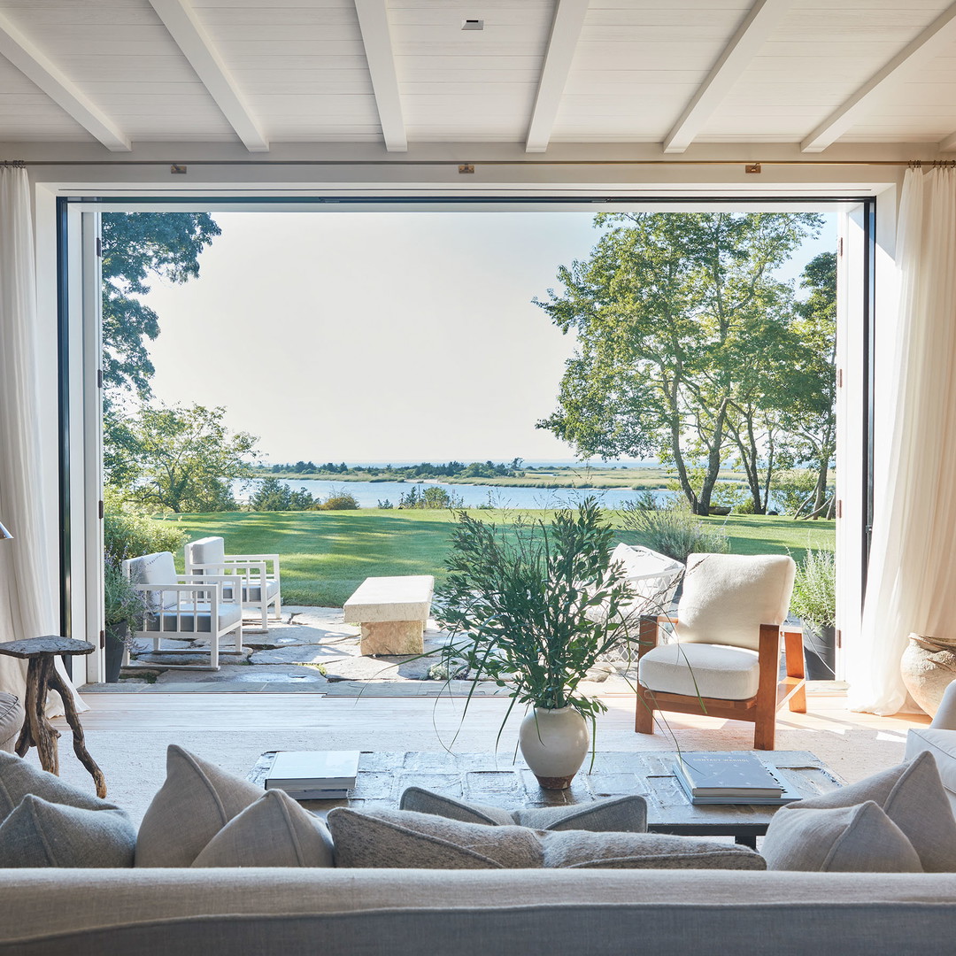 a living room filled with furniture and a large window