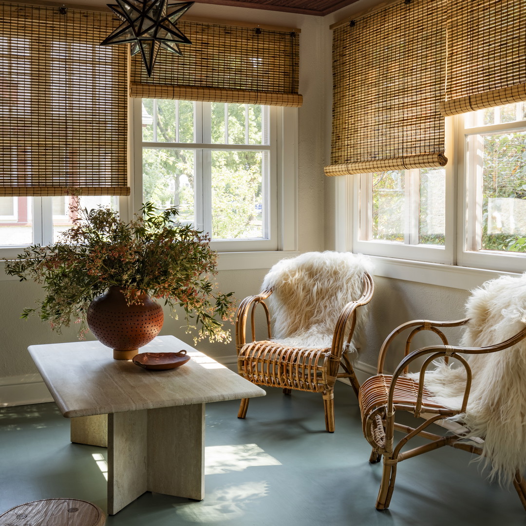 a living room with a table and chairs