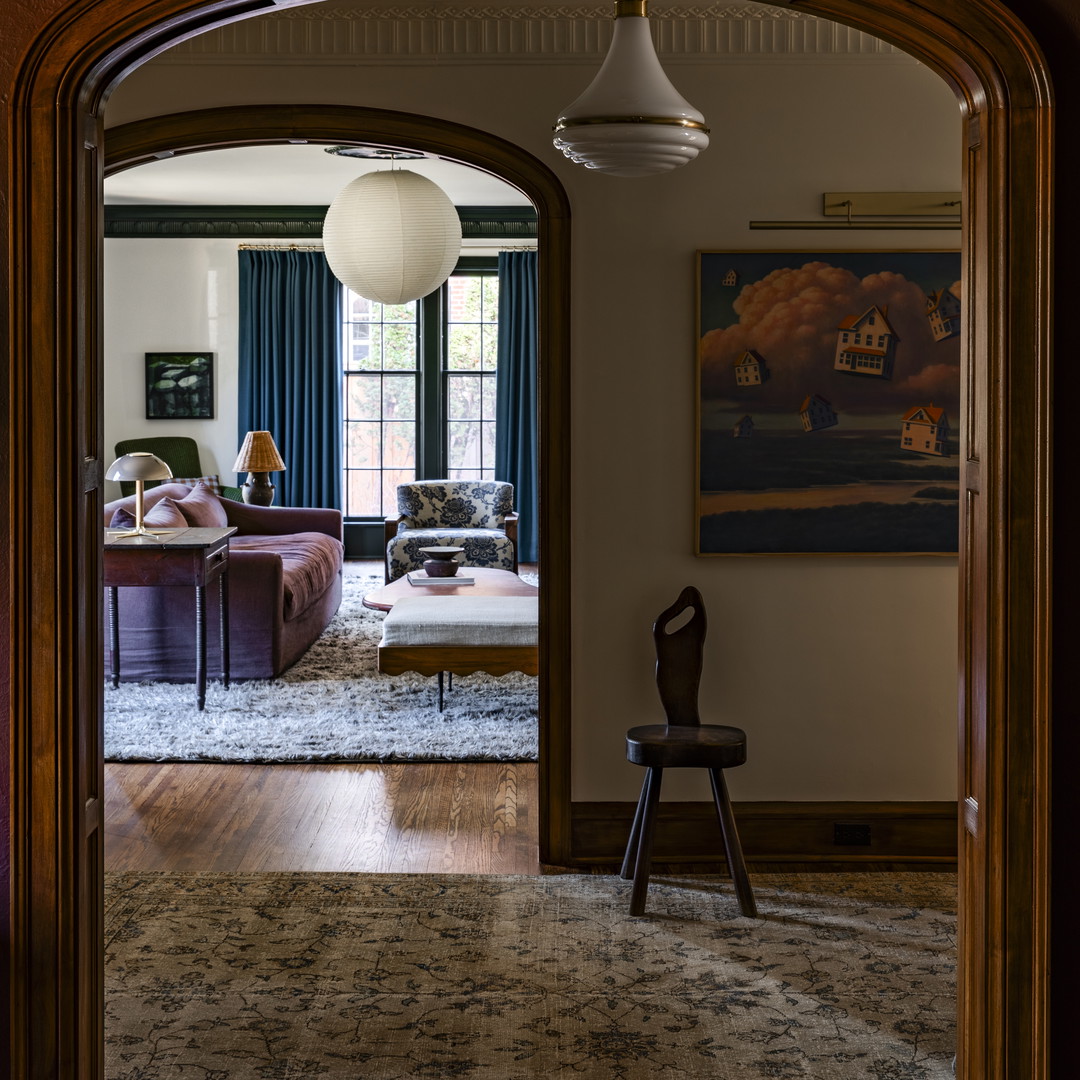 a living room filled with furniture and a large doorway