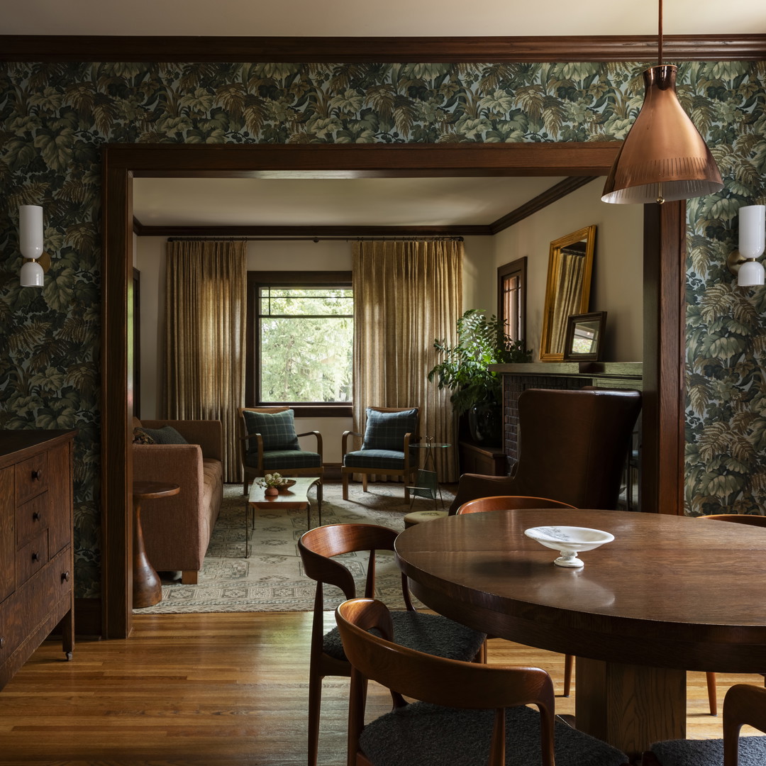 a dining room with a wooden table and chairs