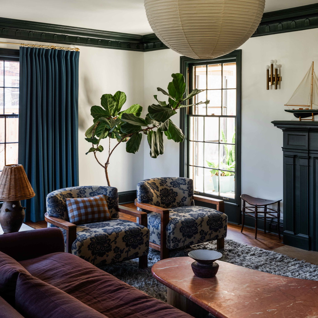 a living room filled with furniture and a potted plant