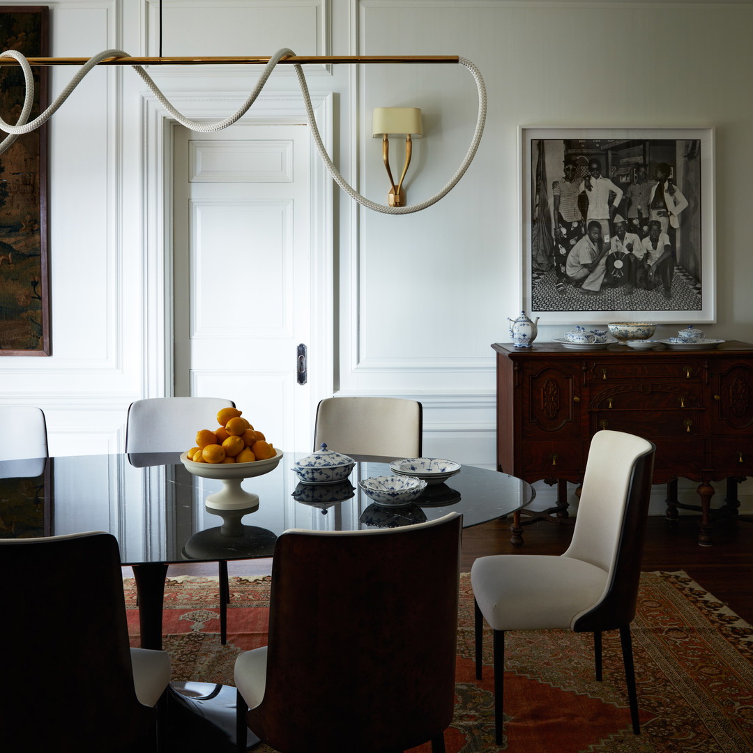 a dining room with a glass table and chairs