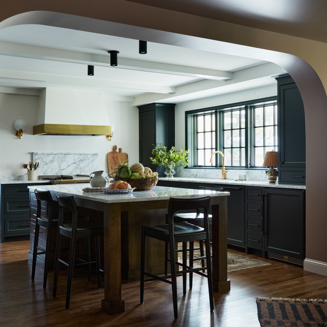 a kitchen with a center island with stools