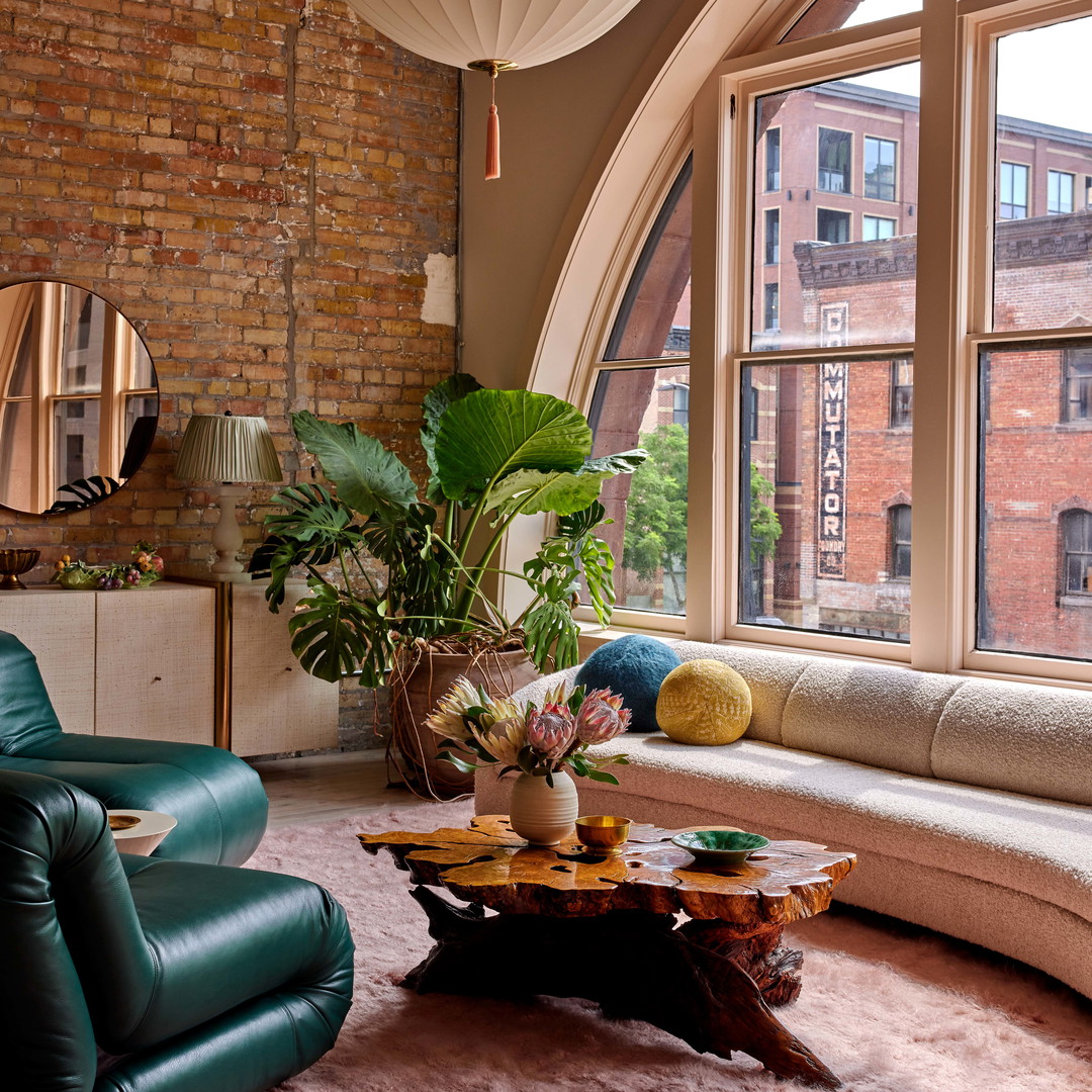 a living room filled with furniture and a large window