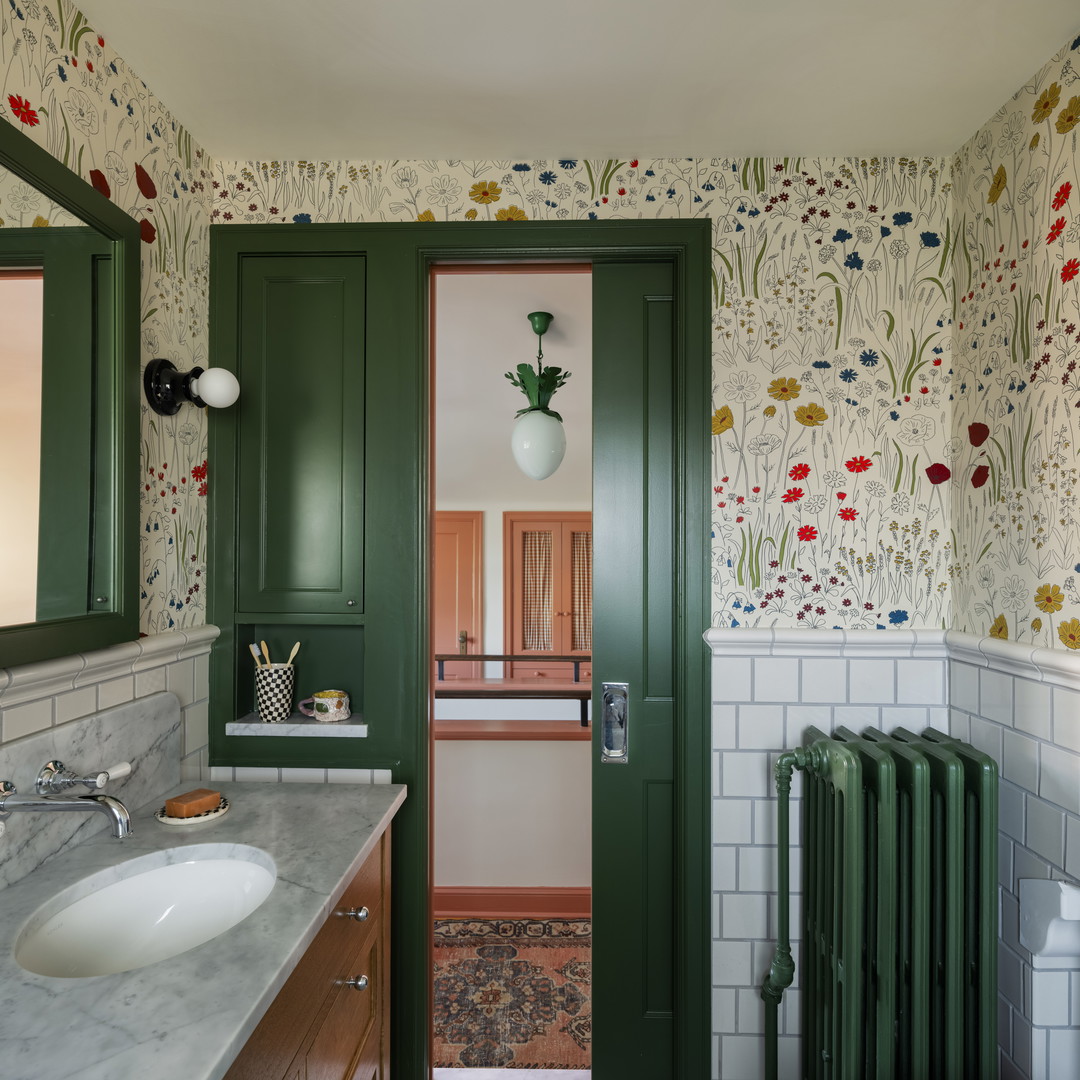 a bathroom with a green door and a white toilet