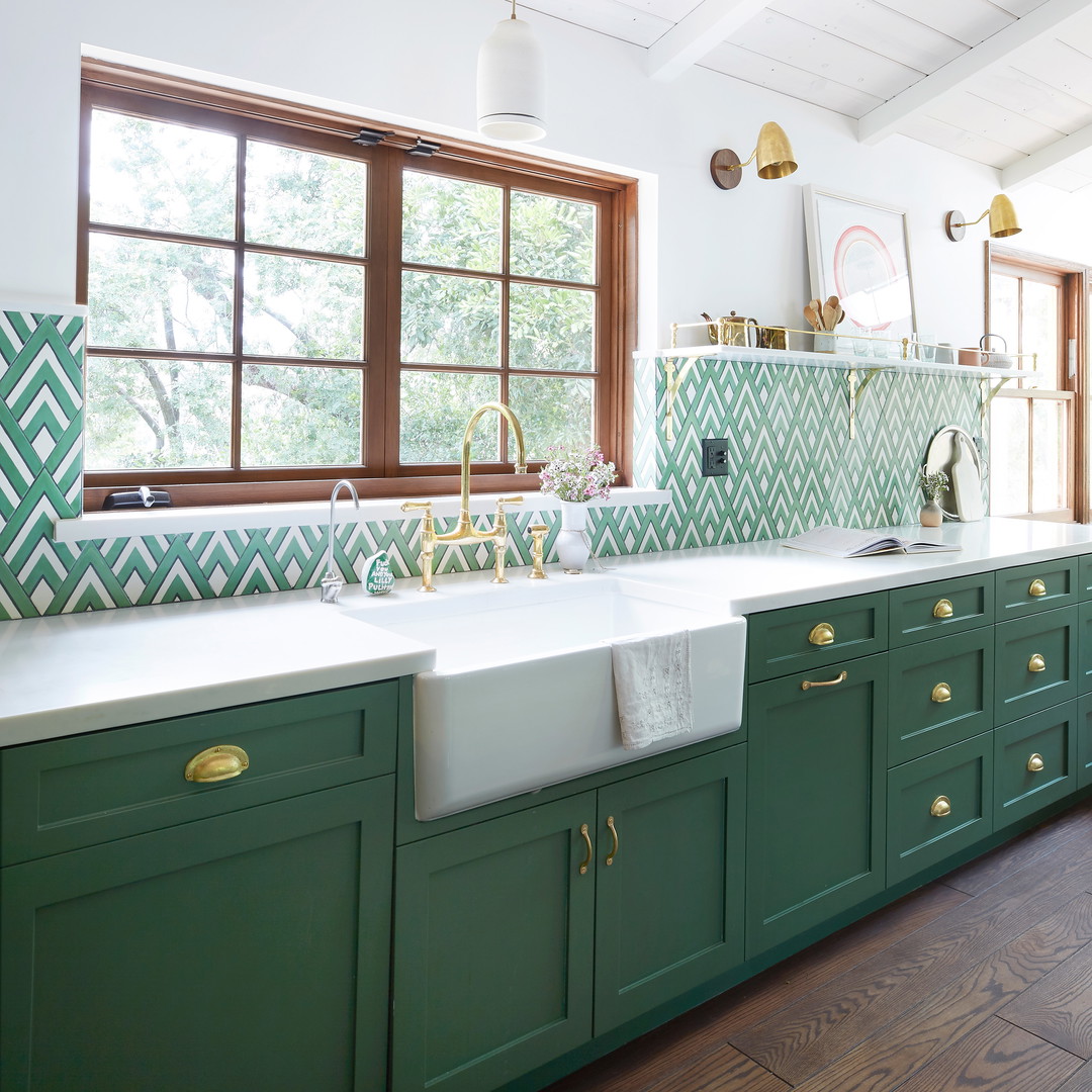 a kitchen with green cabinets and a white sink