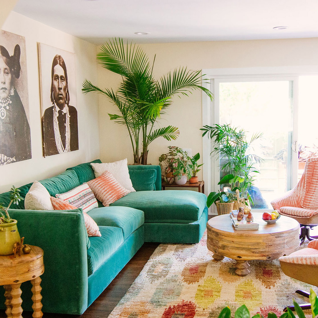 a living room filled with furniture and plants