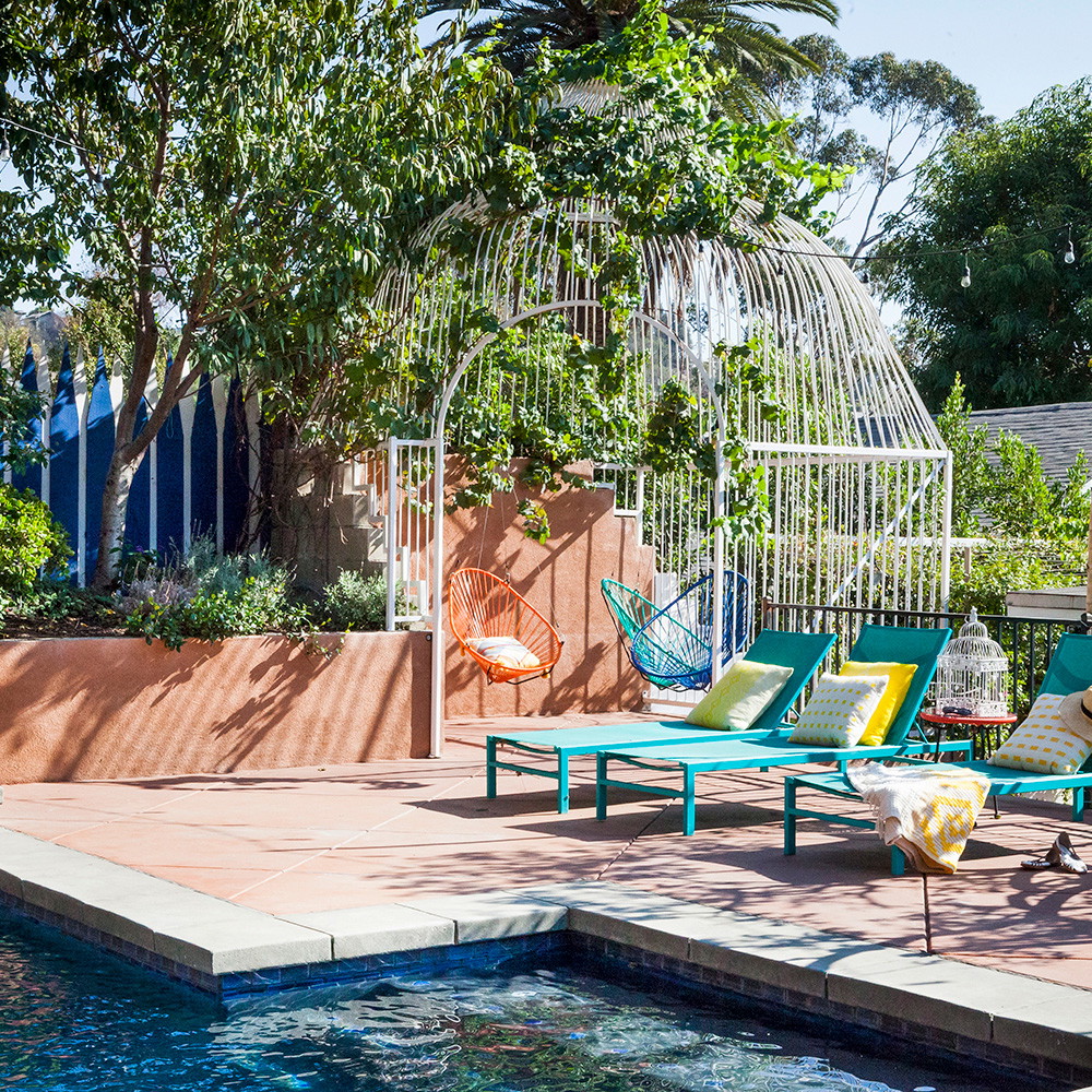 a swimming pool with lounge chairs and a gazebo