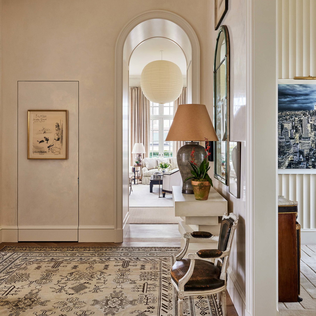 a hallway with a chair and a lamp