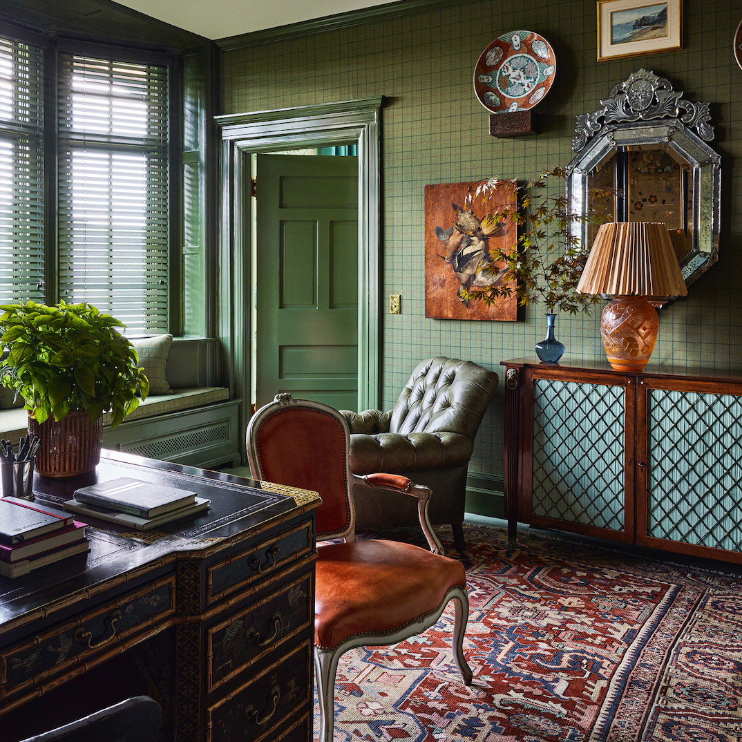 a room with a desk, chair, and a mirror