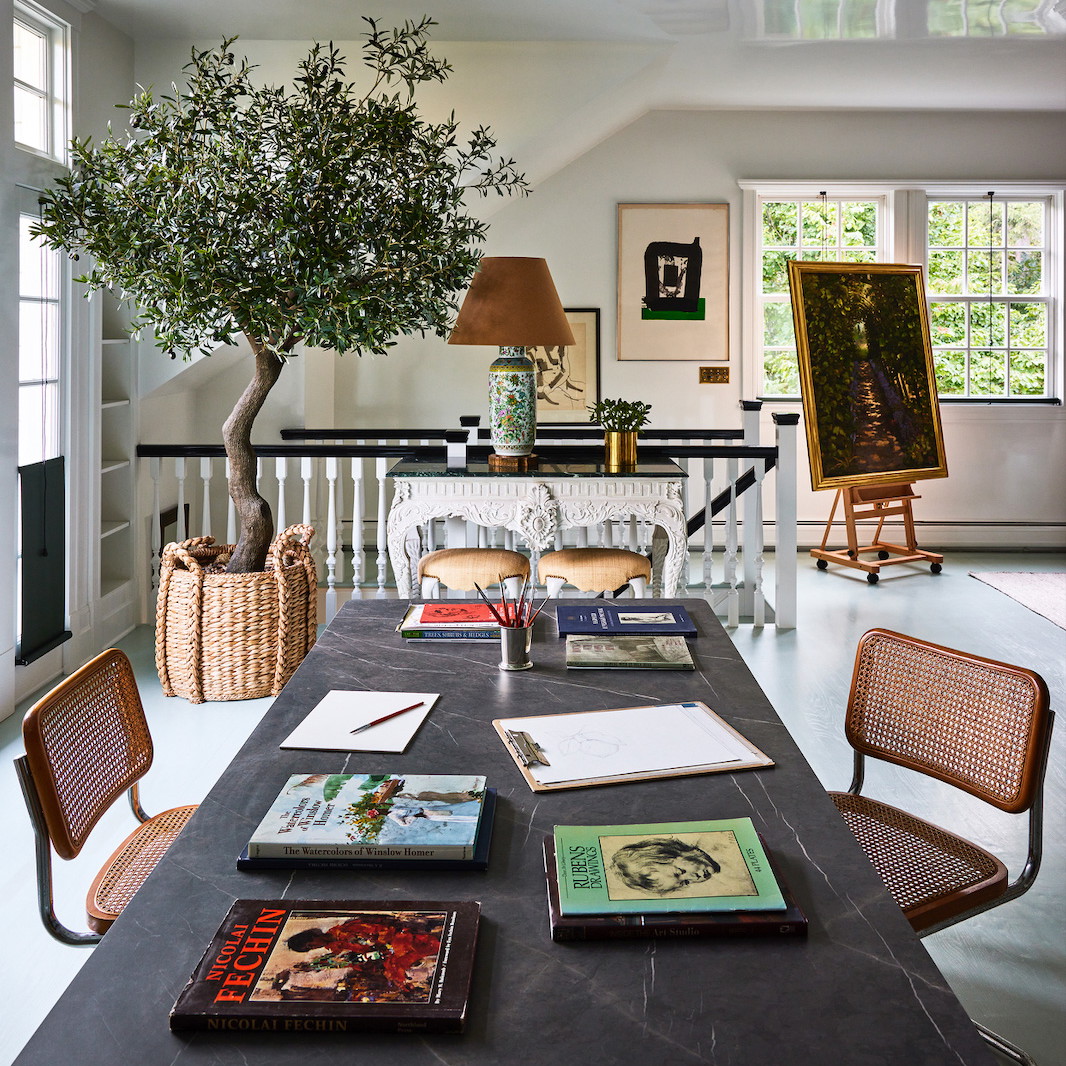 a room with a table and chairs and a tree