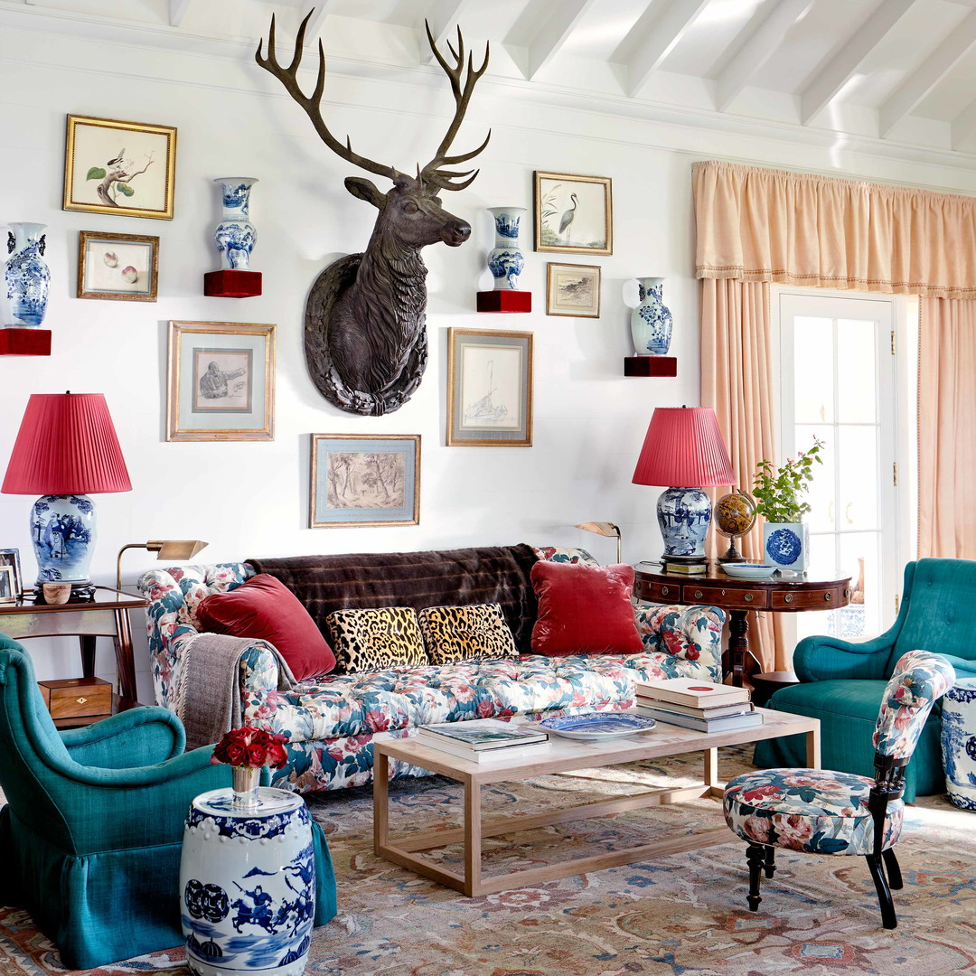 a living room filled with furniture and a deer head