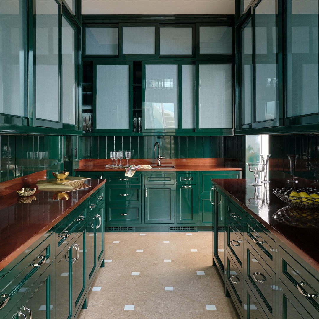 a kitchen with green cabinets and a tiled floor