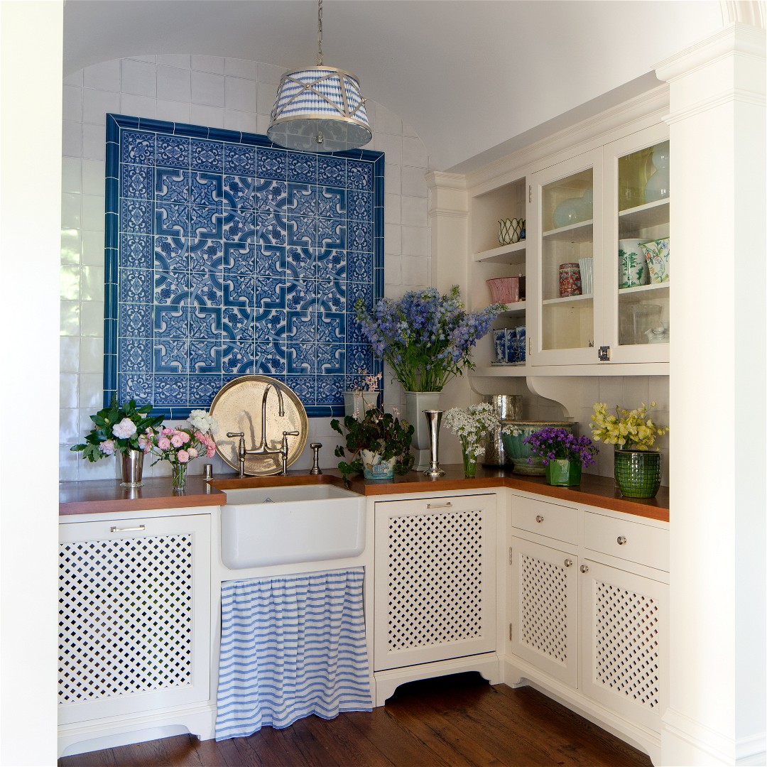 a blue and white tile backsplash in a kitchen