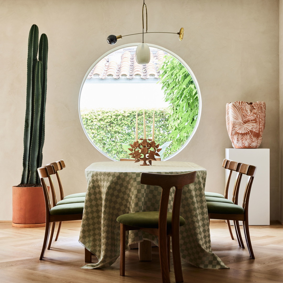 a dining room with a round window and a table