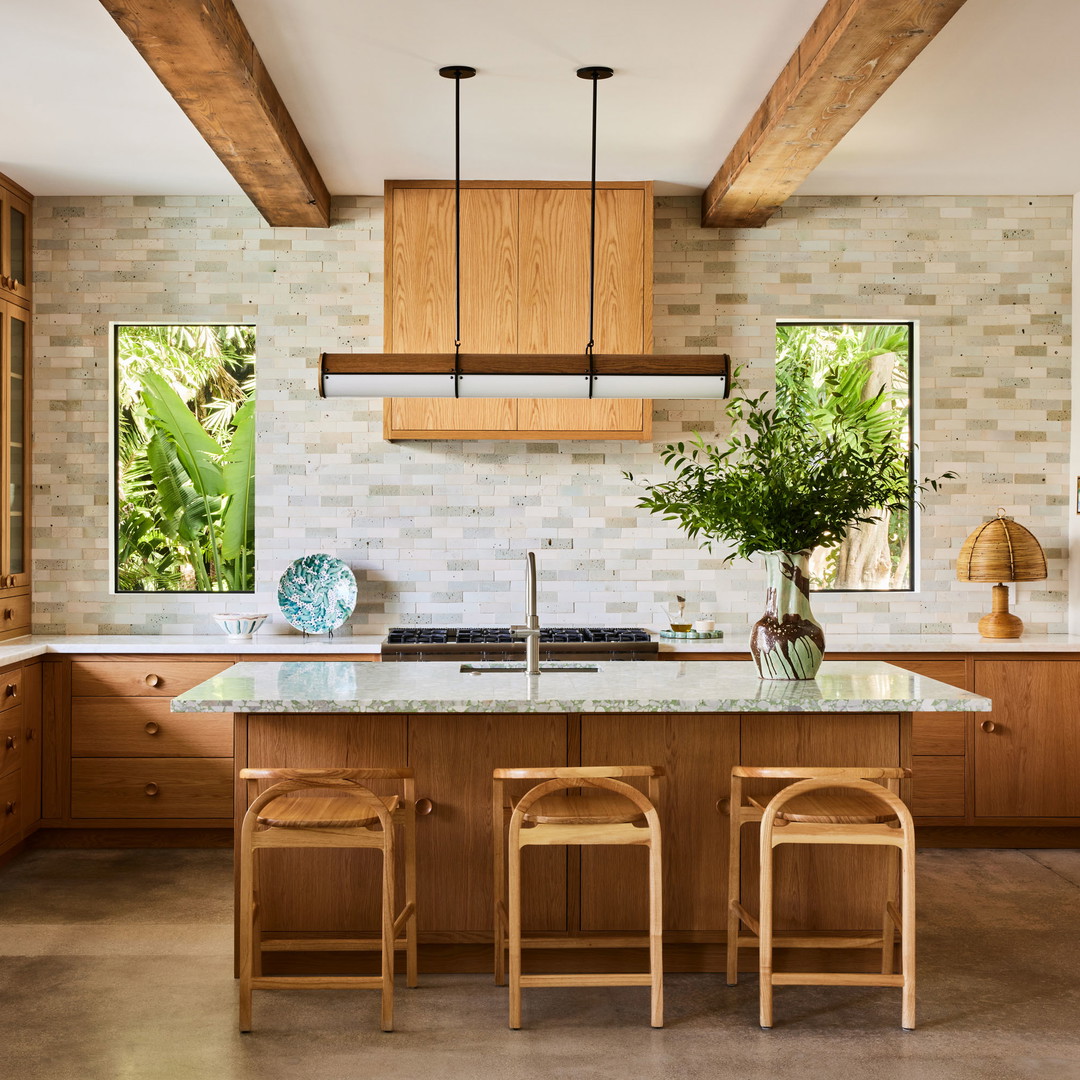 a kitchen with wooden cabinets and a marble counter top